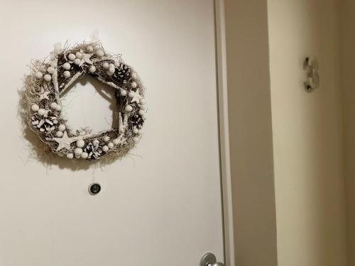 a wreath on the door of a door at Noua Living - Boutique Apartments Ravenna Centro in Ravenna