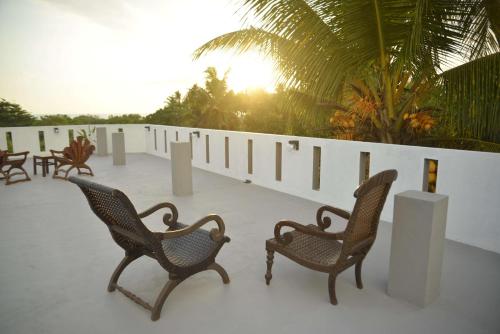 - deux chaises assises au-dessus d'une terrasse dans l'établissement Blue Horizon Villa - Rathgama, à Ratgama Hegoda