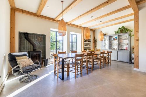 a dining room with a table and chairs and a fireplace at Quinta Revira Volta in Nesperal