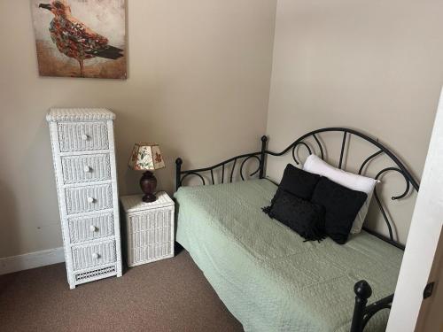 a bedroom with a bed and a dresser with a lamp at Charming Four Bedroom House in Tannersville