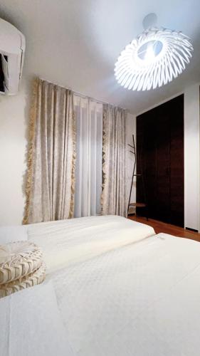 a bedroom with a white bed and a chandelier at Tokyo Hoshino House 1Floor in Tokyo