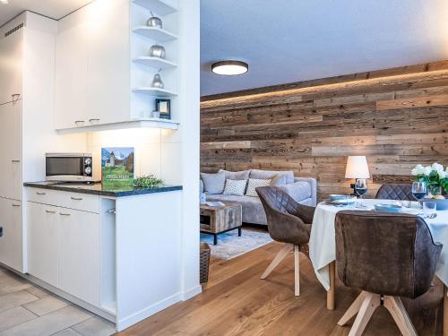 a kitchen and living room with a table and chairs at Apartment Chesa Fleury by Interhome in St. Moritz