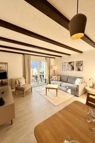 a living room with a couch and a table at Apartment Residenza Chesa Margun 58-5 by Interhome in Surlej