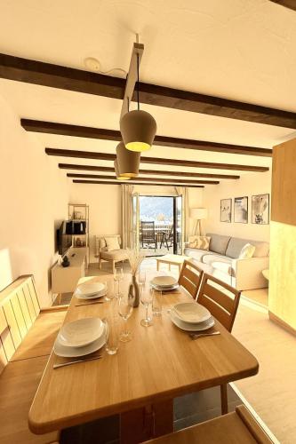 a dining room with a wooden table and a living room at Apartment Residenza Chesa Margun 58-5 by Interhome in Surlej