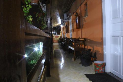 an empty hallway with a table and some plants at Pousada Mar & Vida e Doçaria in Paraty
