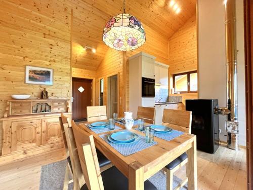 a wooden dining room with a table and chairs at Chalet Chalet Stressless I by Interhome in Presseggen