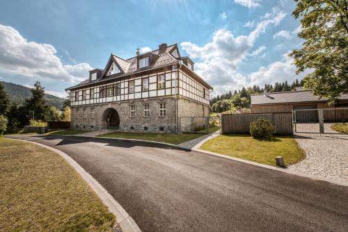 an old house with a road in front of it at Theresian Apartment in Ostružná