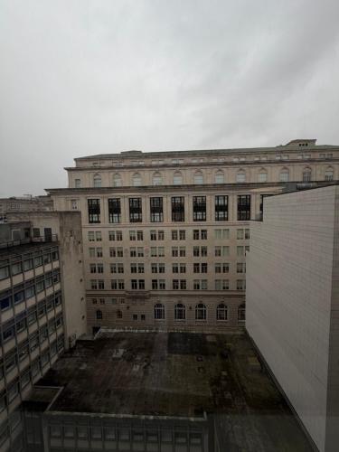 a large building with a lot of windows at Stunning City View Studio Apartment by StaySavvy Accommodation in Liverpool