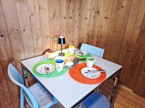 a white table with plates of food on it at Apartment Vreneli by Interhome in Lauterbrunnen