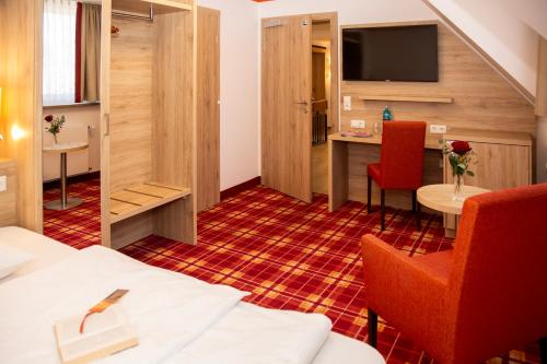 En eller flere senge i et værelse på Hotel Hößl - Wirtshaus zum Stichn