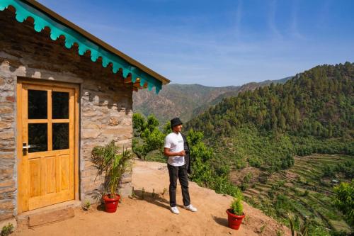 a man standing in front of a building with a view at Indulge Ramgarh by PACK in Rāmgarh