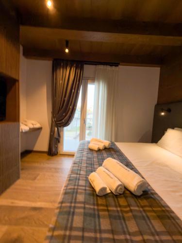 a bedroom with a bed with two towels on it at Luxury Mountain Suites in Roccaraso
