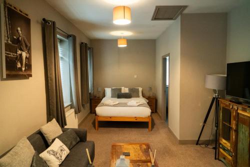 a living room with a bed and a couch at The Milestone in Sowerby Bridge