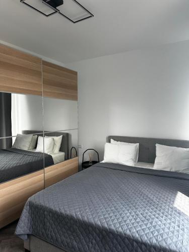 a bedroom with two beds and a mirror at Lake On Exclusive in Mamaia