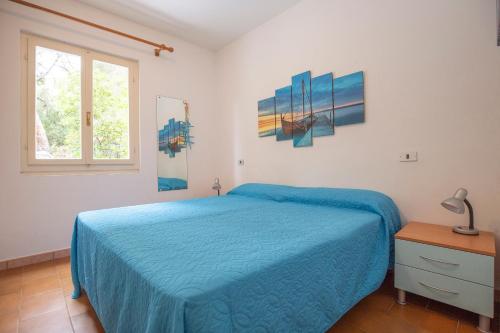 En eller flere senge i et værelse på Casa Acquamarina by ElbaSummer