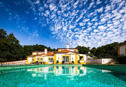 a house with a pool in front of it at Quinta do Pé Descalço Guesthouse Sintra in Sintra