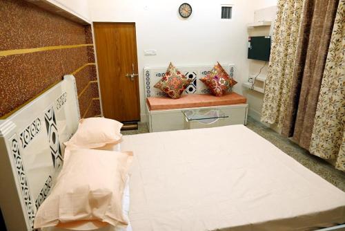 a hospital room with a bed and two pillows at Madhi Basera in Varanasi