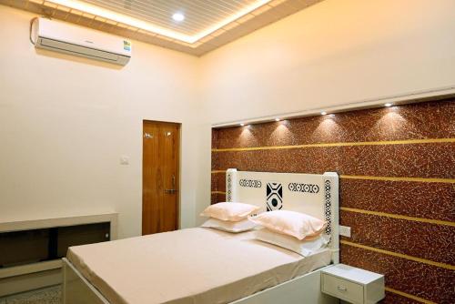 a bedroom with a bed and a wall with a heater at Madhi Basera in Varanasi