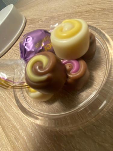 three donuts on a glass plate on a table at Apartment am Waldrand in Itzehoe