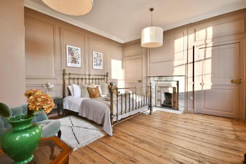 a bedroom with a bed and a fireplace at 1 Purfleet Quay in King's Lynn