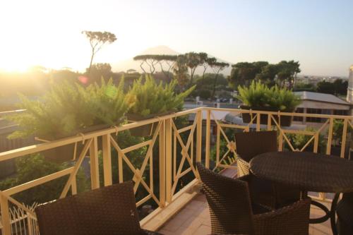 a balcony with chairs and a table and plants at Pompei suite via roma 16 in Pompei
