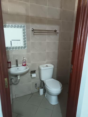 a bathroom with a toilet and a sink at Studio BNB Meru town CBD in Meru