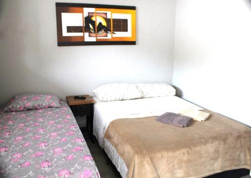 En eller flere senge i et værelse på Pousada Captain Morgan Pontal do Sul com Piscina