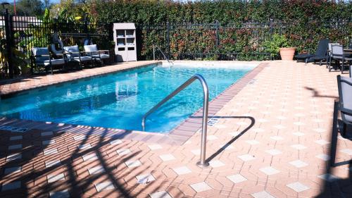a small swimming pool with chairs around it at Hampton Inn and Suites Houston-Katy in Katy