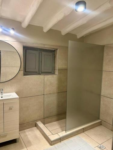 a bathroom with a sink and a mirror at La Remigia in San Juan