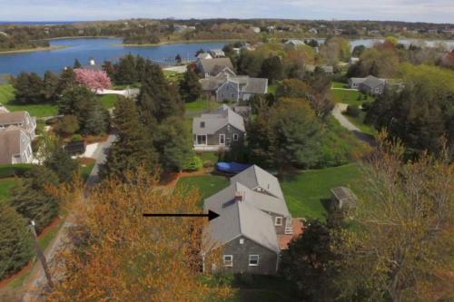 an aerial view of a house with a lake at Walk to Water w Stunning Cove Views in Eastham
