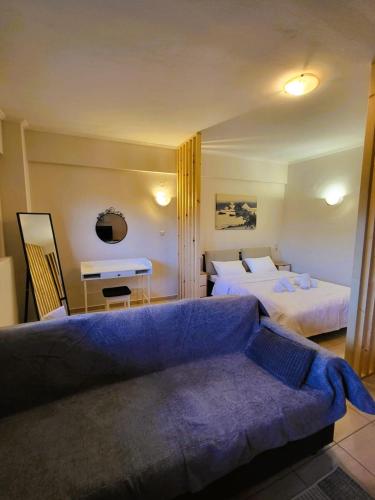 a hotel room with two beds and a couch at Despina's house in Ioannina