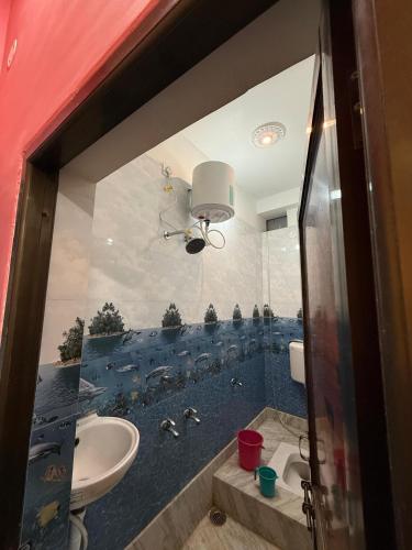 a bathroom with a sink and a toilet and a mirror at Hotel DK Inn sasaram in Sasarām