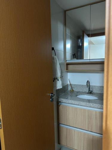 a bathroom with a sink and a mirror at Studio On Mateus in Juiz de Fora