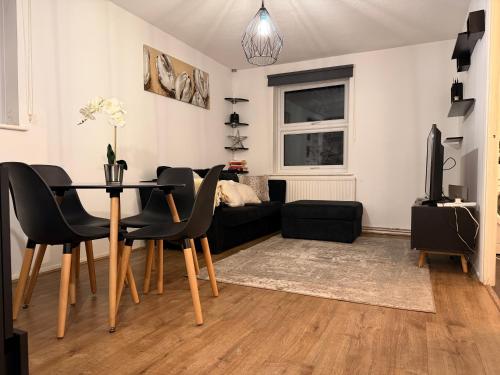 a living room with a table and a couch at HRF Hackney Apartments in London