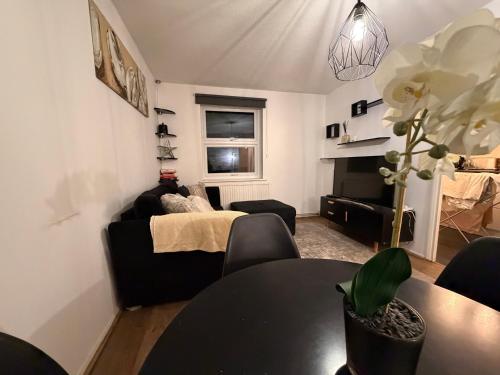 a living room with a couch and a table at HRF Hackney Apartments in London