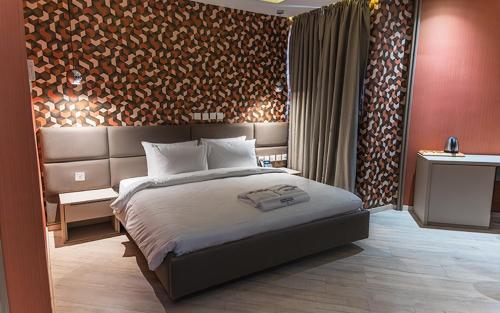 une chambre avec un grand lit dans une pièce dans l'établissement Atlanticblu hotels & Resort, à Abuja