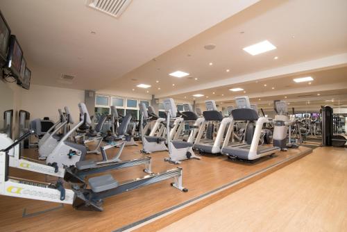 a gym with rows of treadmills and ellipticals at Regency Park Hotel, Health Club & Spa in Newbury