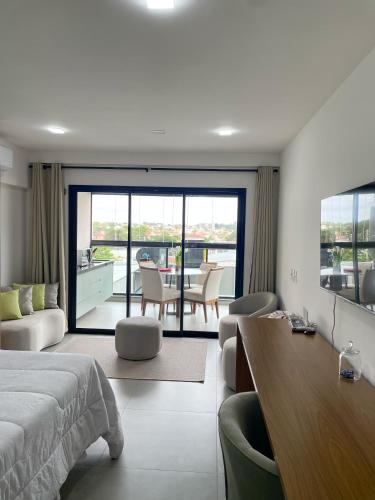 a bedroom with a bed and a table and chairs at Flat Apartamento Av Esmeralda em Marília in Marília