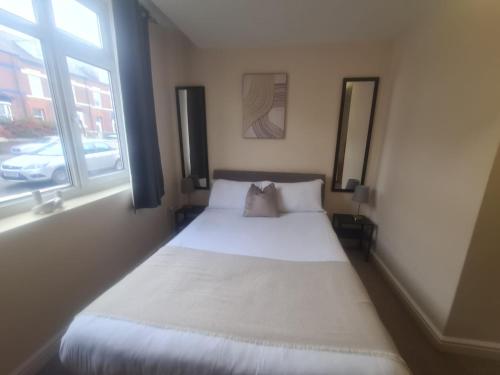 a small bed in a room with a window at West Park One Bedroom in South Shields