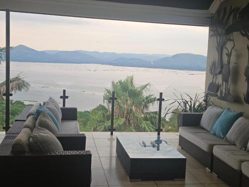 a living room with a view of the water at Mi Casa in Hartbeespoort