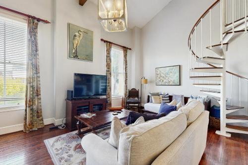 a living room with a couch and a tv at 195 East Bay in Charleston