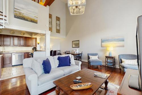a living room with a white couch and a table at 195 East Bay in Charleston