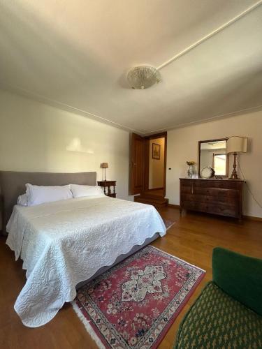 a bedroom with a bed and a mirror and a rug at La Maison in Mestre