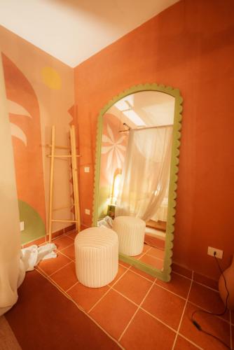 a bathroom with a mirror and a white stool at Tzila Bahariya in Bawati