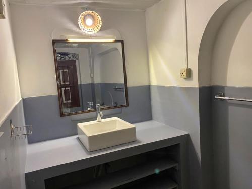 a bathroom with a sink and a mirror at Avalon Villa Unawatuna in Unawatuna