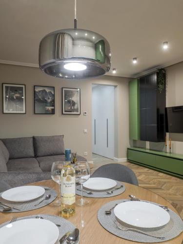a dining room with a table with plates on it at Arhitect INN in Sibiu