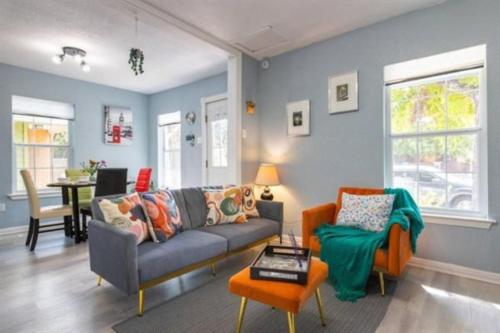 a living room with a couch and a table at Award winning Cultural Heritage home -Walk to Lake, La BBQ & Eateries in Austin