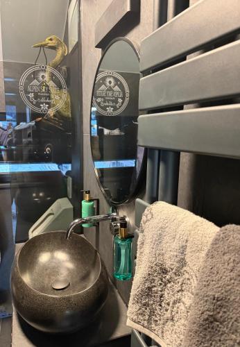 a bathroom with a sink and a mirror at Alpen Sky Suite Flachau in Flachau