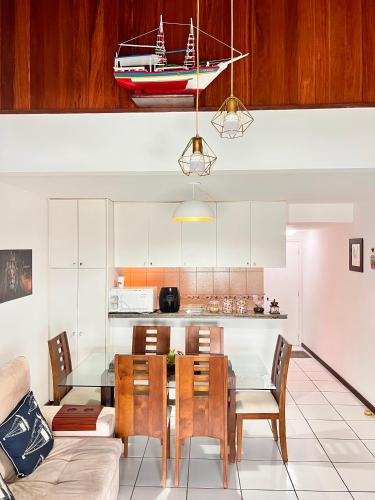 a kitchen and dining room with a table and a boat on the ceiling at Angra Sea House in Angra dos Reis