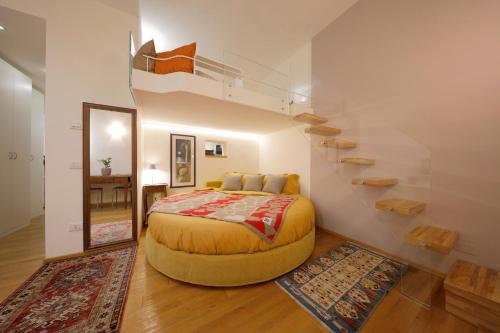 a bedroom with a bed and a spiral staircase at Siena UpTown - Sabrina's Cozy Apartment in Siena